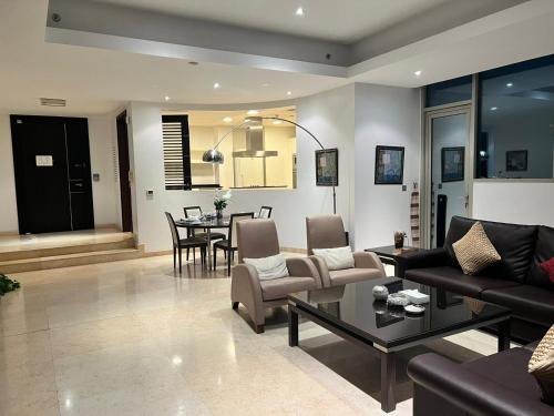 a living room with a couch and a table at Butterfly Residence in Manama