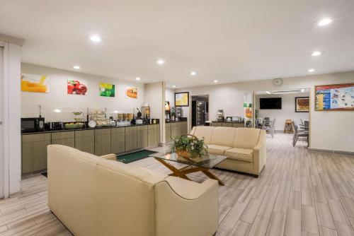 a lobby with two couches and a table and a counter at Quality Inn Northlake in Tucker