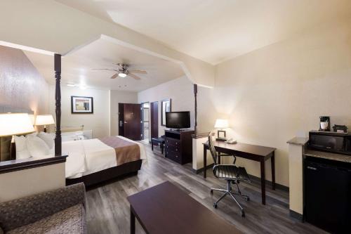 a hotel room with a bed and a desk at Quality Inn and Suites Terrell in Terrell