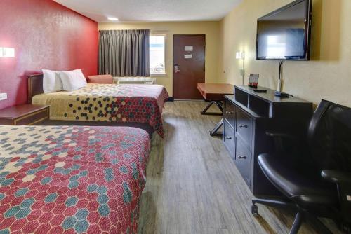 a hotel room with two beds and a flat screen tv at Econo Lodge Town Center in Virginia Beach