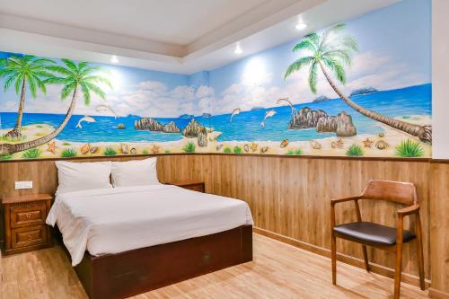 a bedroom with a bed and a mural at Azura Gold Hotel & Apartment in Nha Trang