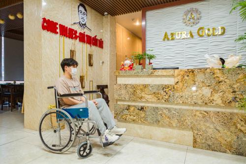 a man sitting in a wheelchair wearing a mask at Azura Gold Hotel & Apartment in Nha Trang