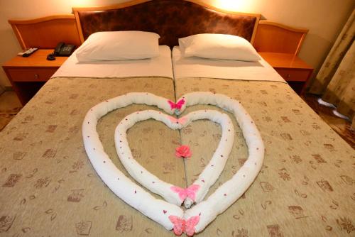 a bed with two hearts painted on it at Sappho Hotel in Skala Eresou