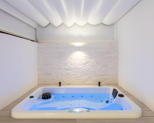 a bathroom with a blue tub in a room at The Terraces Luxury Penthouses, 3D in Santa Cruz de Tenerife