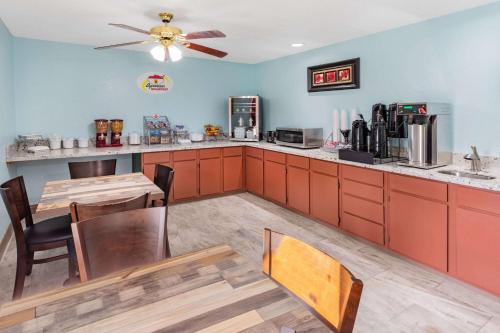 a kitchen with a table and a dining room at Super 8 by Wyndham Kinder/Coushatta near Casino in Kinder