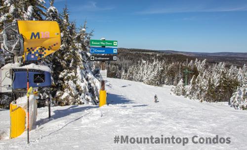 a snow covered ski slope with a ski lift at Mountaintop Condos in Snowshoe