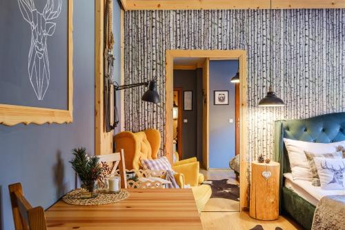 a living room with a table and a couch at WIlla JODŁA JACUZZI&SAUNA in Poronin
