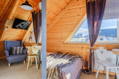 a room with a bed and a window at WIlla JODŁA JACUZZI&SAUNA in Poronin