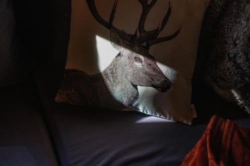 a picture of a deer head on a pillow at WIlla JODŁA JACUZZI&SAUNA in Poronin