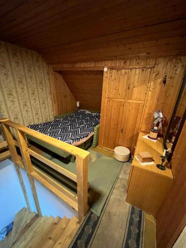 a small room with a bed in a cabin at Zelena oaza in Divčibare