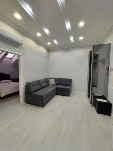 a living room with a couch in the middle of a room at Apartament Vip Chirie in Chişinău
