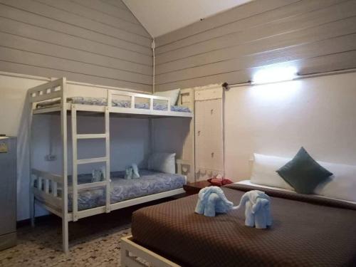 a bedroom with two bunk beds and two elephants at LUCKY PAI Resort&Hostel in Pai
