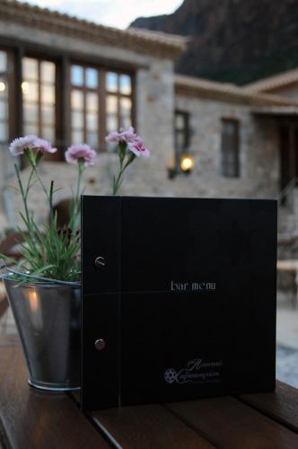 a black box sitting on top of a table with flowers at Archontiko Hatzipanayioti in Leonidion