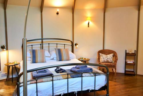 a bedroom with a bed with blue towels on it at Finest Retreats - Buzzard Luxury Treehouse Hideaway in Dittisham