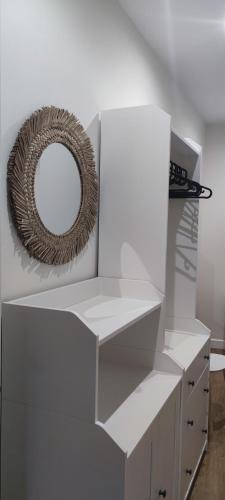 a white shelf with a mirror on top of it at El balcón de Carmen in O Barqueiro