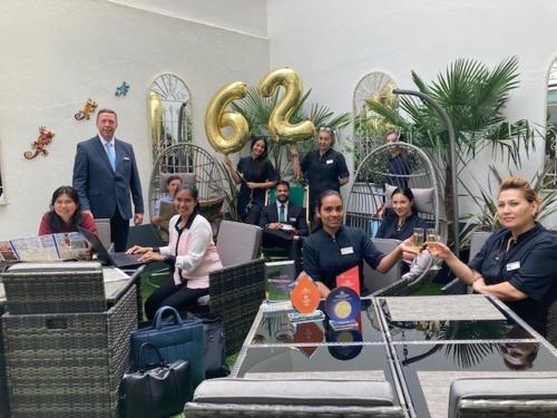a group of people sitting at tables in a room at Astor Court Hotel in London