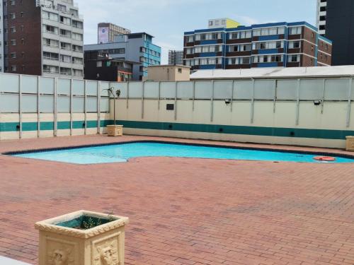 an empty swimming pool on the roof of a building at Unit 802 Ten South in Durban