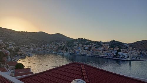 a view of a city with a river and buildings at Pitini Nikos house in Symi