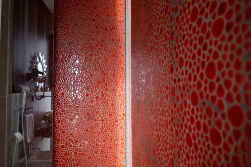 a bathroom with a red shower with a red wall at Divina Charme in Mascalucia