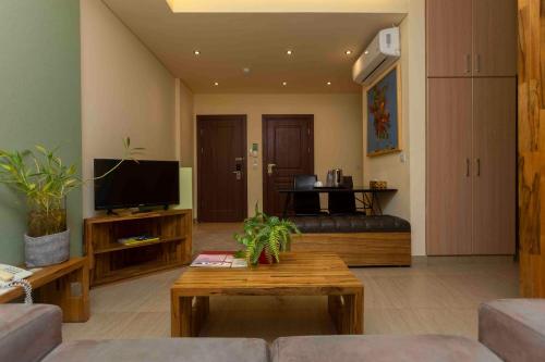 a living room with a couch and a coffee table at Roots Hotel Apartment in Accra