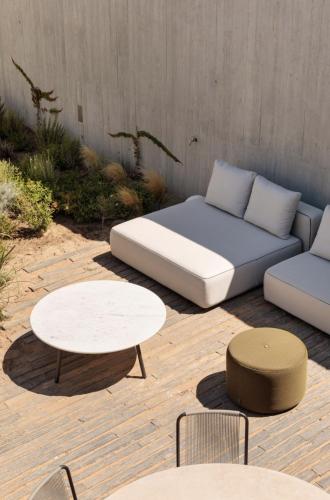 a bed and two tables and a couch and tables at Pa.te.os in Melides