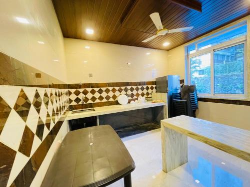 a kitchen with a bench and a sink in a room at Prime Villa in Lonavala