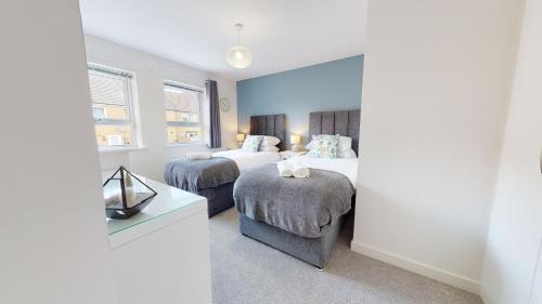a hotel room with two beds and a mirror at Sparrowbill House by Cliftonvalley Apartments in Bristol