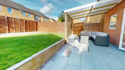 a patio with a couch and chairs on a lawn at Sparrowbill House by Cliftonvalley Apartments in Bristol