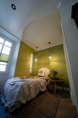 a bedroom with a bed and a table in it at CASA BELGERI - Bed & Breakfast in Dongio