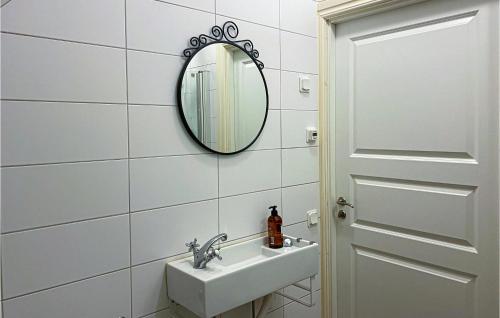 a bathroom with a sink and a mirror at Amazing Apartment In Visby With Kitchen in Visby