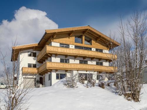 a large building with snow in front of it at Haus Seisl in Söll