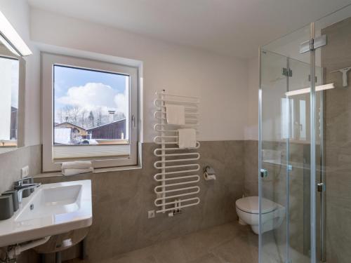 a bathroom with a toilet and a sink and a shower at Haus Seisl in Söll