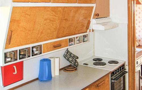 a small kitchen with a stove and a refrigerator at Awesome Home In Torup With Wifi in Torup