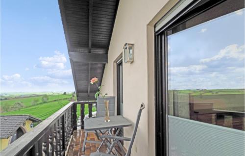 a balcony with a table and a view of the countryside at 2 Bedroom Cozy Apartment In Karlshausen in Karlshausen
