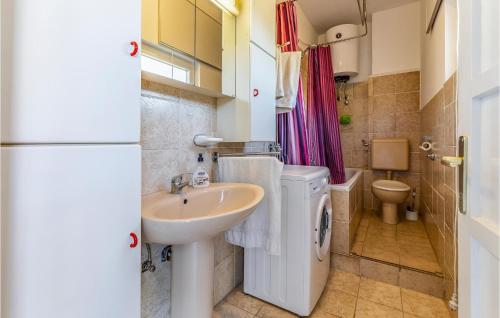 a small bathroom with a sink and a toilet at 2 Bedroom Gorgeous Apartment In Pula in Pula