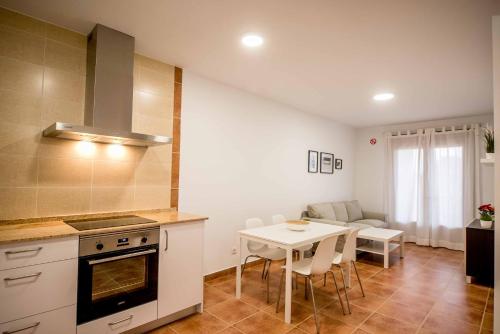 a kitchen and dining room with a table and chairs at Apartamentos AL PASO DE TOLEDO, Puy du Fou a 10km in Burguillos de Toledo