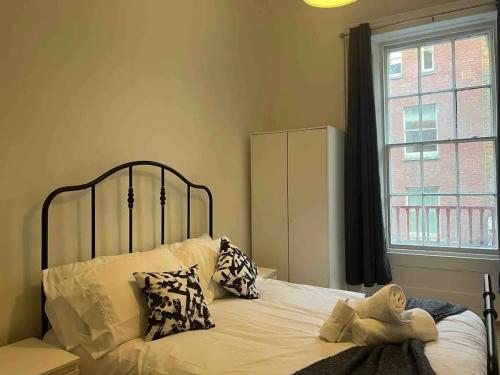 a bedroom with a bed with a stuffed animal on it at Stay in the heart of Soho in London