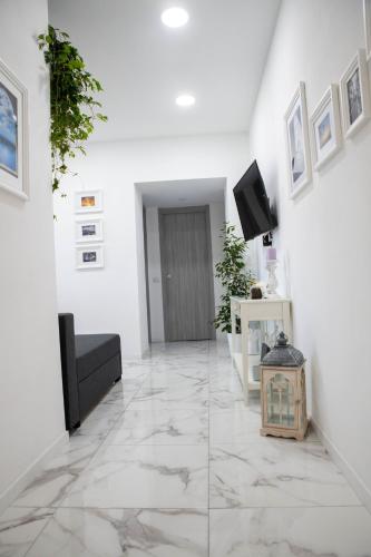 a living room with white walls and marble floors at B&B Carpe Diem in Castel Gandolfo