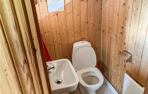 a small bathroom with a toilet and a sink at Nice Home In Lima With Sauna in Lima