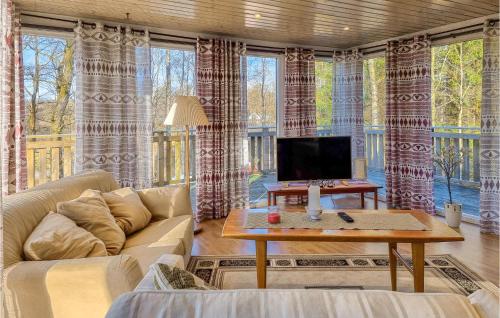 a living room with a couch and a tv at Beautiful Home In Yngered With Wifi in Yngered
