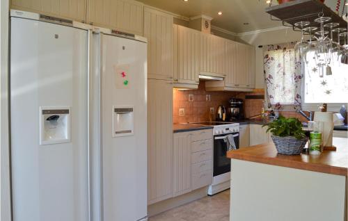 a kitchen with a white refrigerator and a stove at 4 Bedroom Nice Home In Trosa in Trosa