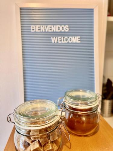 two jars of honey on a table with a welcome sign at San Carlos rentals - Lastarria in Santiago