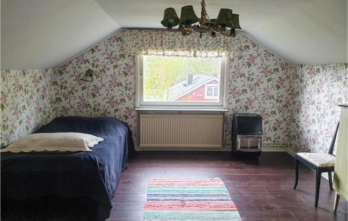 a bedroom with a bed and a window at 4 Bedroom Nice Home In Trosa in Trosa