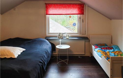 a small bedroom with two beds and a window at 4 Bedroom Nice Home In Trosa in Trosa