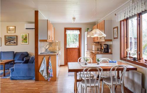 a kitchen and living room with a table and chairs at Beautiful Home In Hyltebruk With Wifi in Hyltebruk