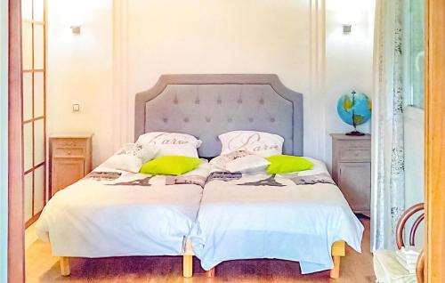 1 Schlafzimmer mit 2 Betten mit weißer Bettwäsche und gelben Kissen in der Unterkunft Awesome Home In Saint-pe-sur-nivelle With House A Mountain View in Saint-Pée-sur-Nivelle