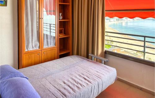 a room with a bed and a window with a view at Amazing Apartment In Benidorm With Outdoor Swimming Pool, Swimming Pool And 1 Bedrooms in Benidorm