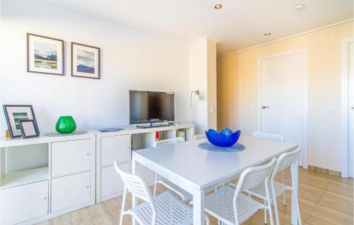 a white dining room with a white table and chairs at Stunning Apartment In Santa Pola in Santa Pola