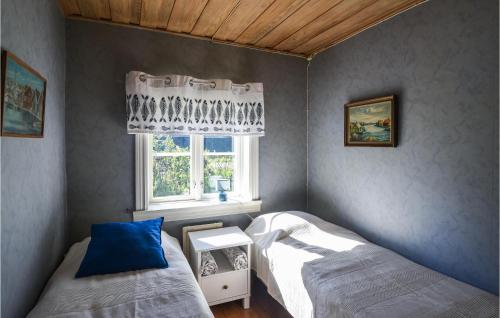 a bedroom with two beds and a window at Nice Home In Munkedal With Lake View in Munkedal