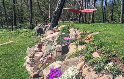 an umbrella hanging over a rock garden with flowers at Amazing Home In Höör With Wifi in Höör